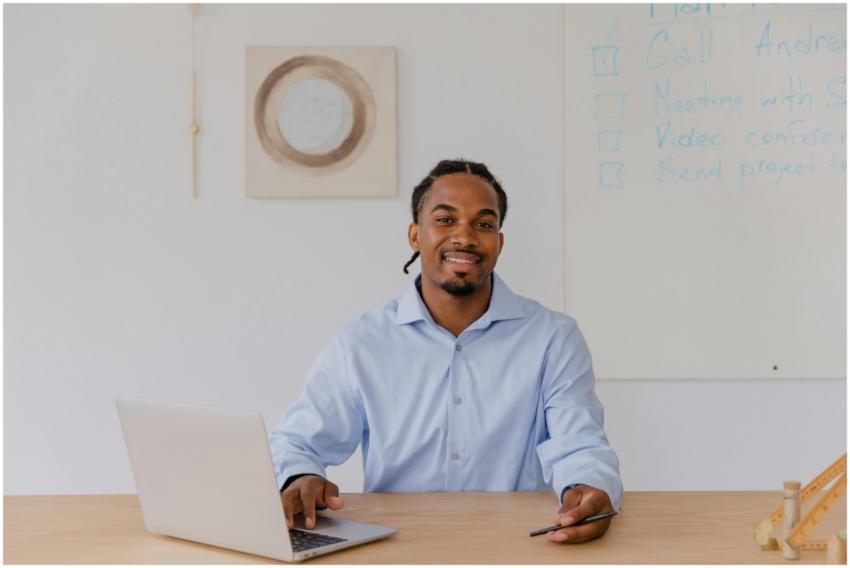 Confident businessman smiling while working on a l