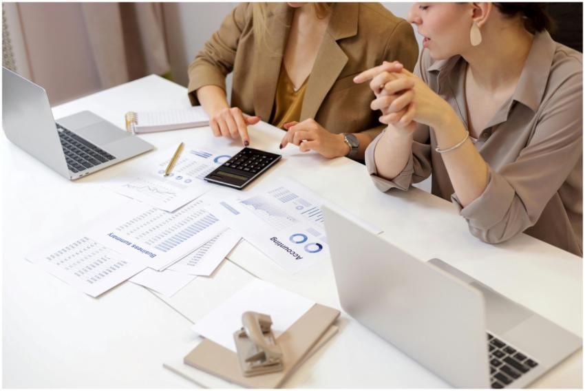 Two professionals collaborating on financial docum