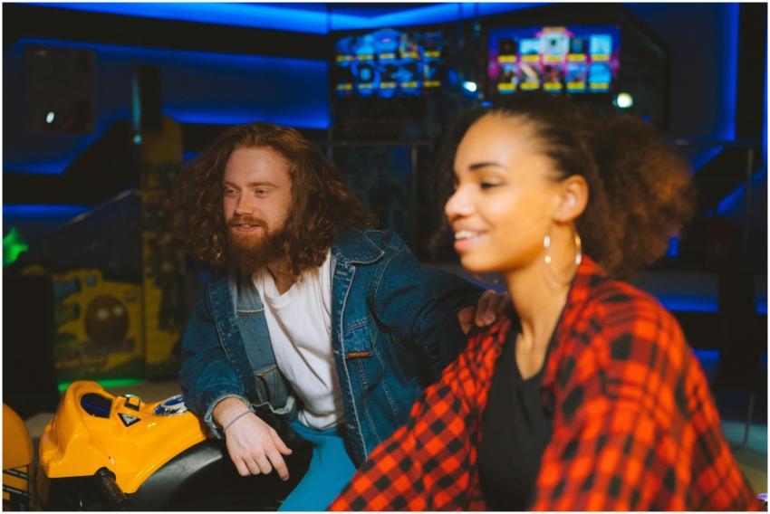 A happy couple having fun indoors at an amusement