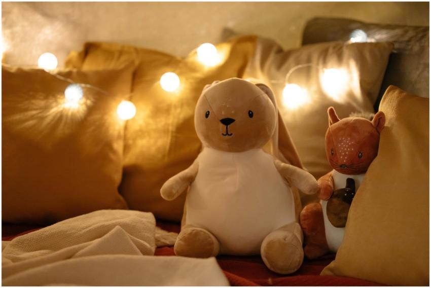 Warm and inviting bedroom scene with plush toys, p
