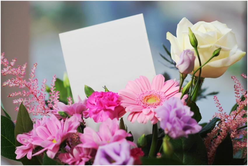 A colorful bouquet of flowers with a blank card, p
