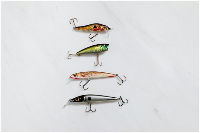 Variety of fishing lures arranged on a white surfa