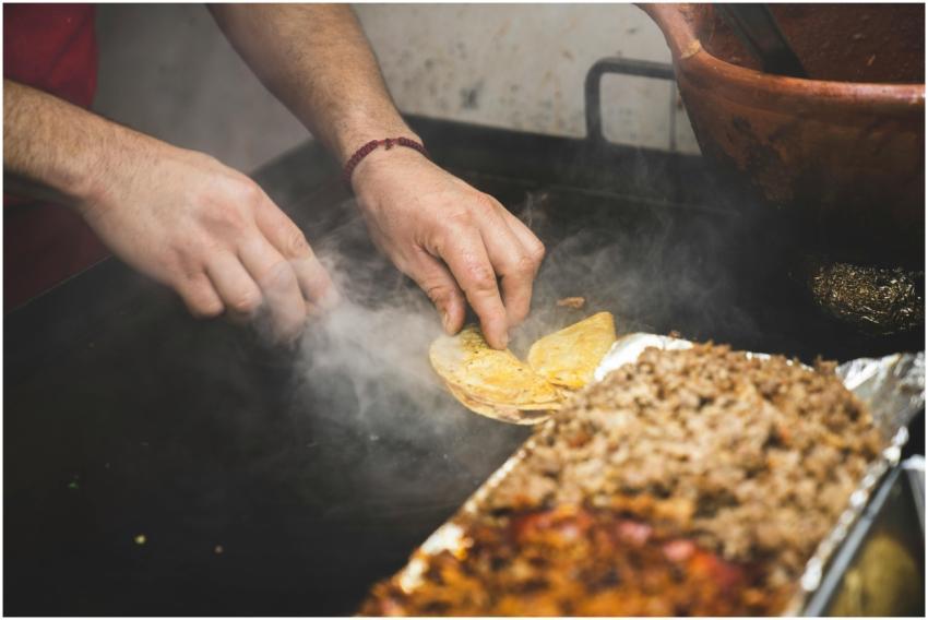 Vendor skillfully prepares authentic Mexican stree