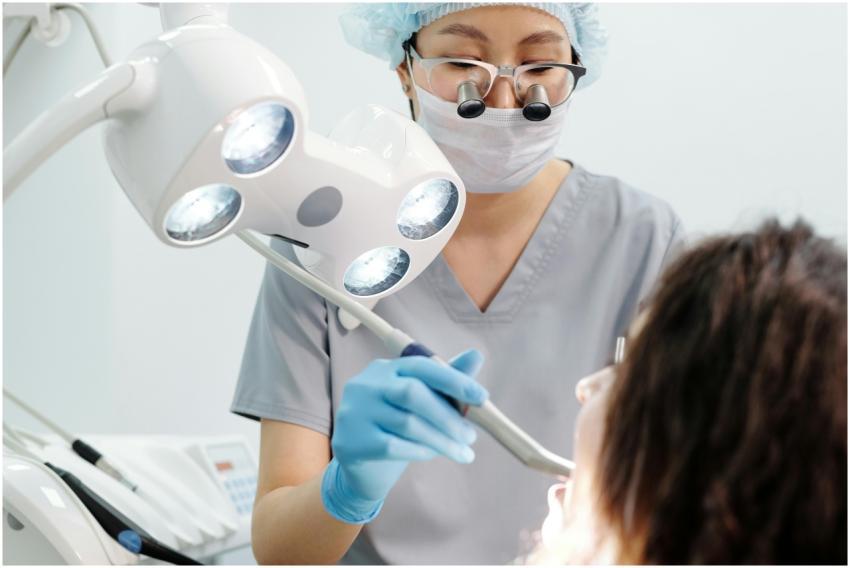 Dentist using tools and lights during a dental exa