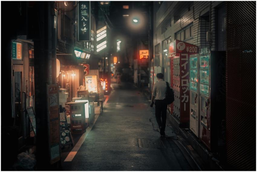 A quiet night scene depicting a person strolling t