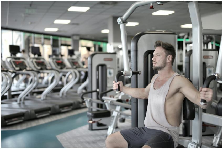 Man exercising on chest press machine in a modern