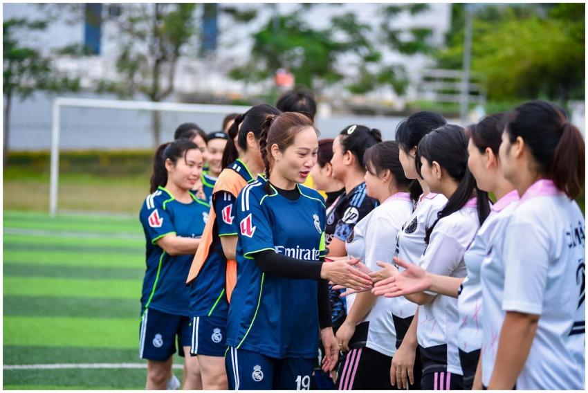 Women's football teams exchanging handshakes on a