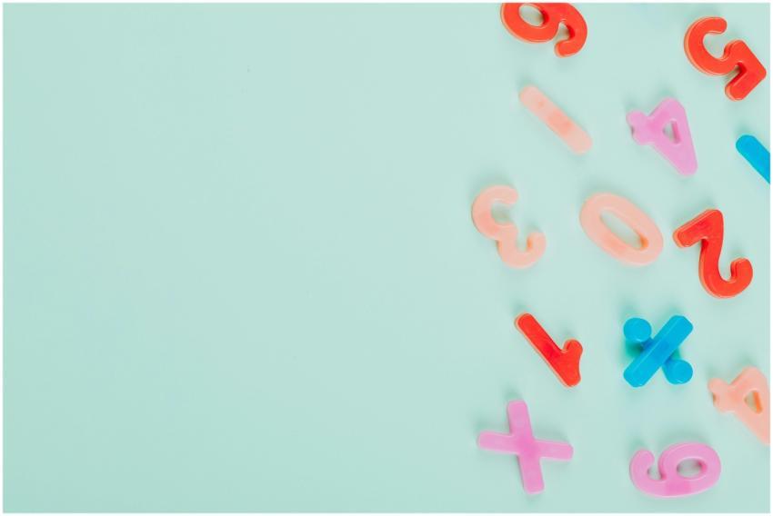 Vibrant plastic numbers arranged on a light teal b