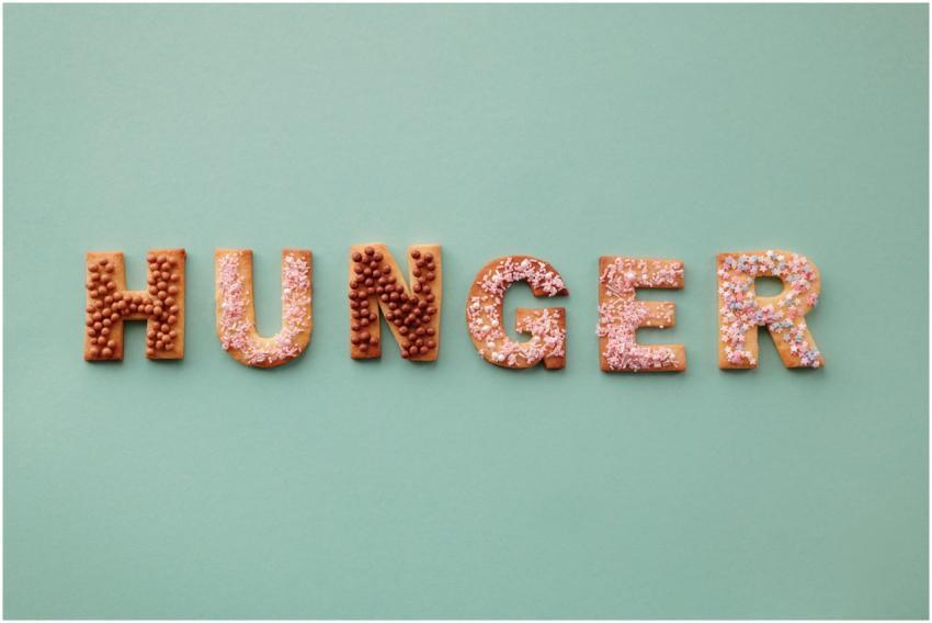 Colorful cookies spelling the word 'Hunger' on a p