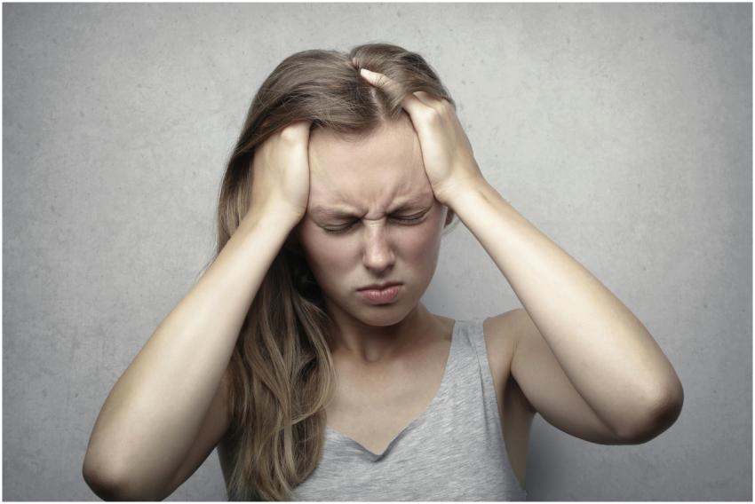 Young woman expressing stress and frustration whil