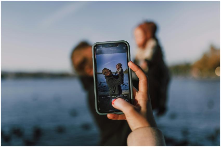 A father lifting his child against a serene outdoo
