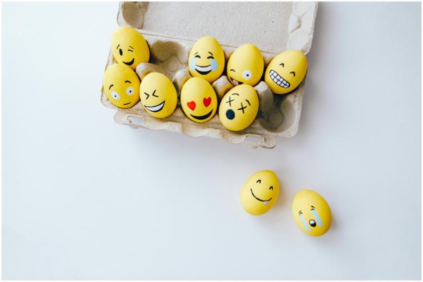 Colorful yellow Easter eggs decorated with emoji f
