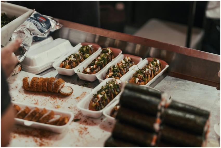 Close-up of various sushi rolls with toppings in a