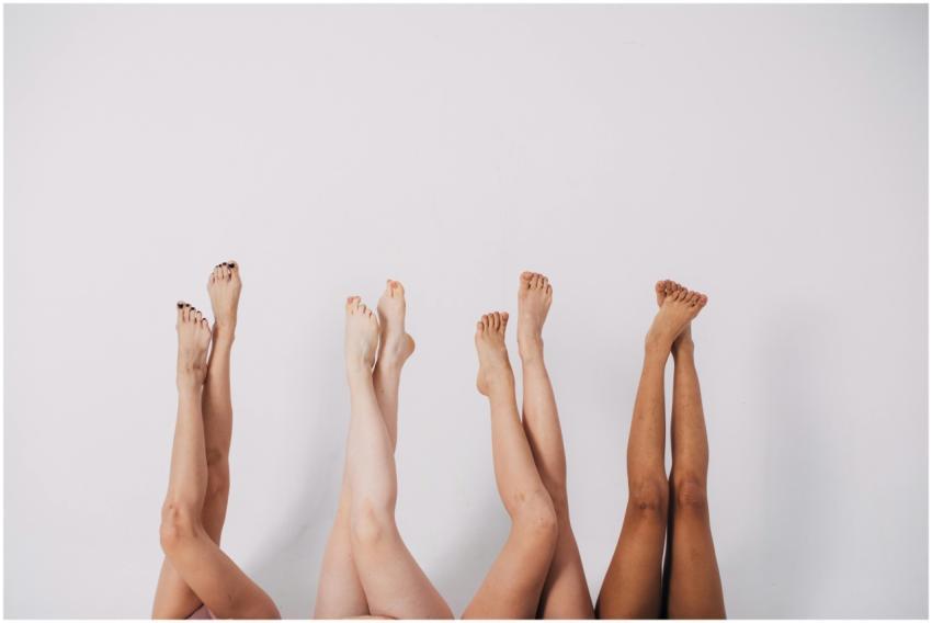 Four pairs of legs raised against a white backgrou