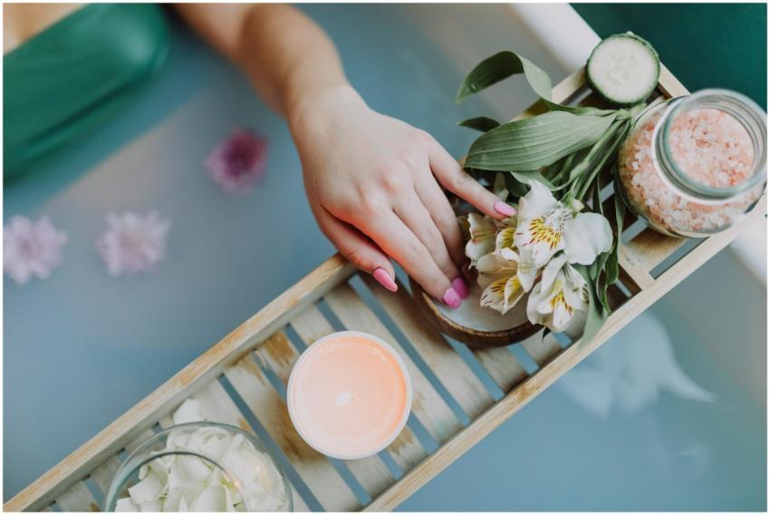 Elegant spa setting with flowers, bath salts, and