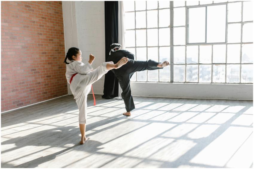 Two martial artists practicing high kicks in a bri