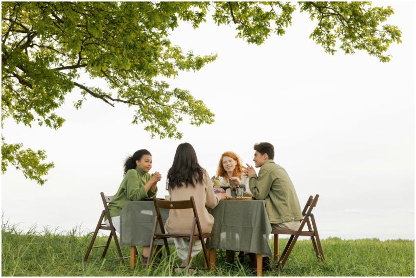A diverse group of friends at an outdoor picnic, e