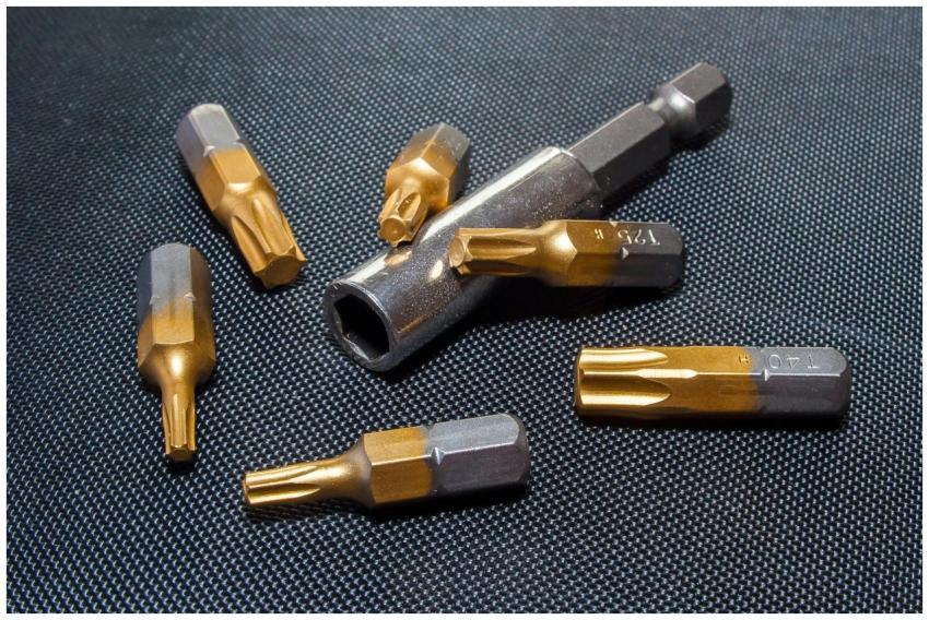A detailed close-up of metallic tool bits arranged