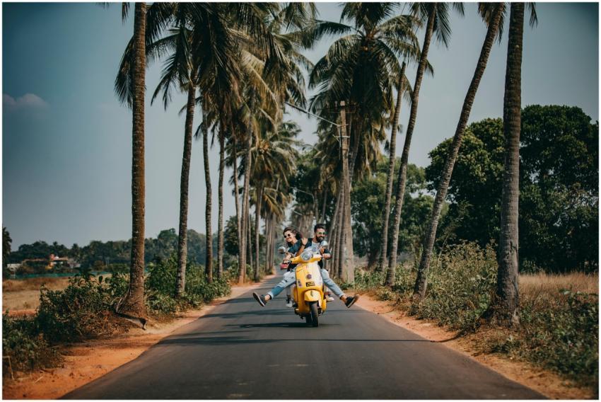 A joyful couple rides a yellow scooter through a s