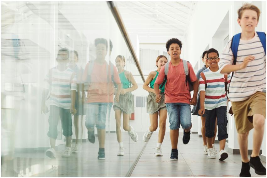 Energetic children with backpacks running in a mod