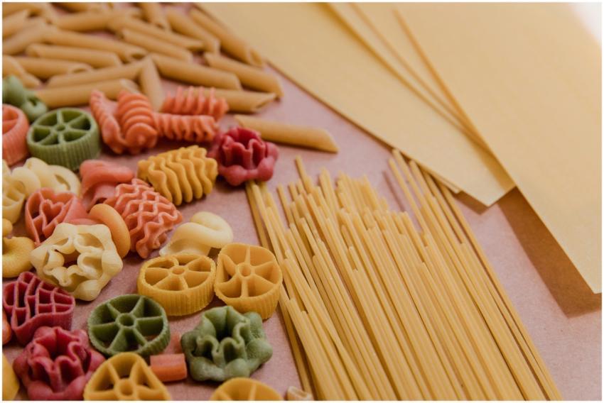 Vibrant selection of uncooked pasta shapes includi