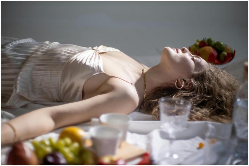 Young female with fair hair lying near sweet delic