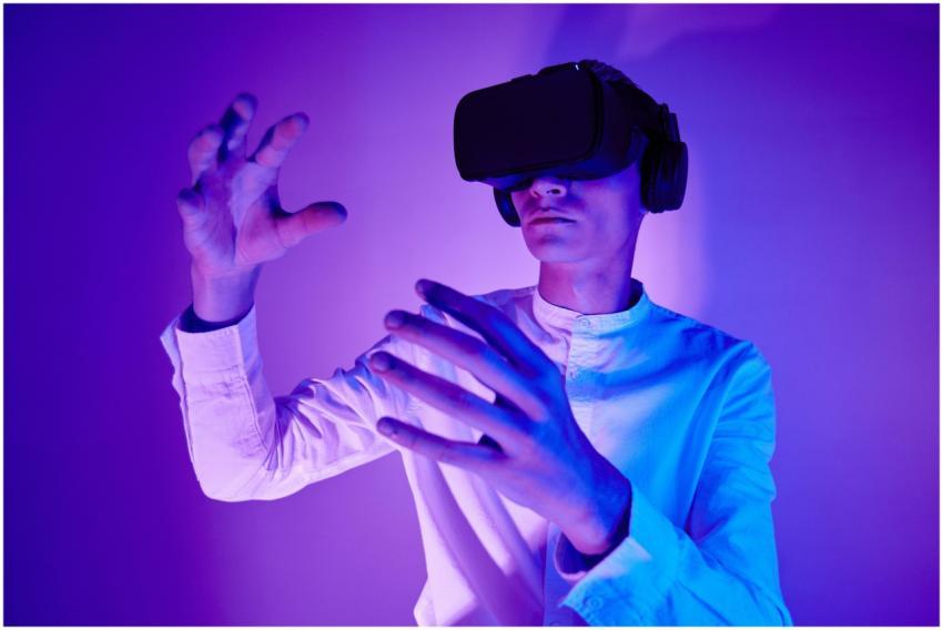 A man wearing VR goggles interacts with a virtual