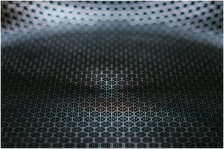 Dark abstract textured metallic surface with geome