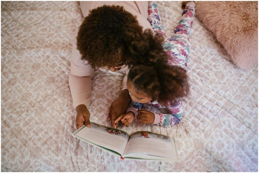 A mother and daughter enjoying storytime on a cozy