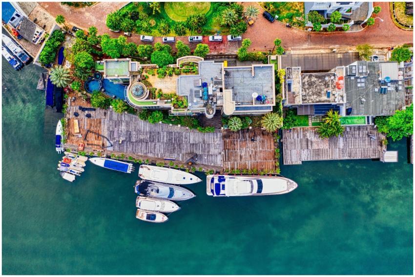 Aerial shot of luxurious waterfront homes with yac
