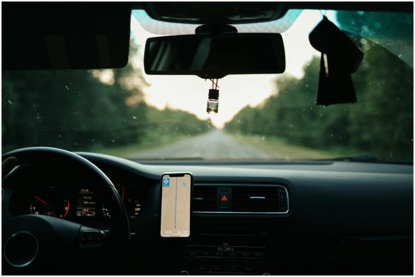 View of a car interior with a GPS on a scenic road