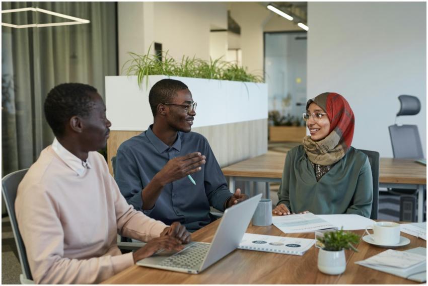 Three colleagues engaged in a collaborative discus