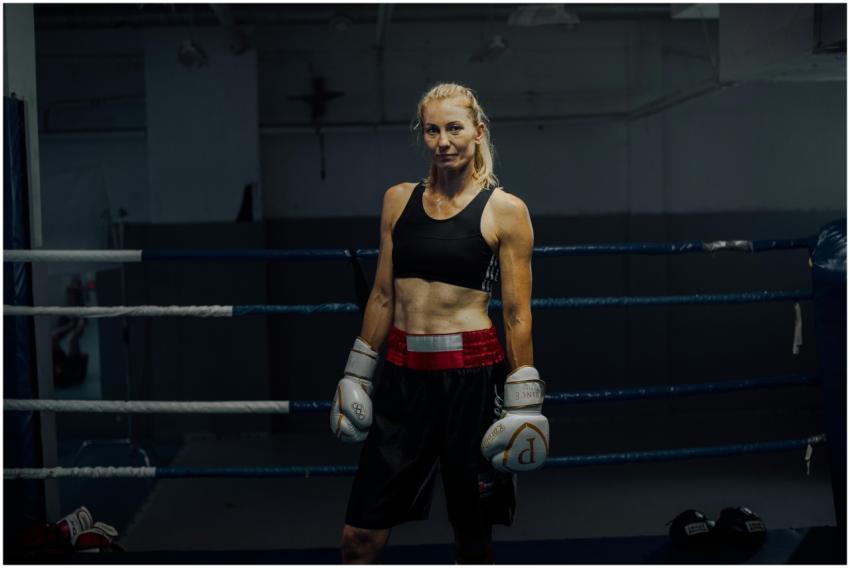 Strong female boxer standing confidently in the bo