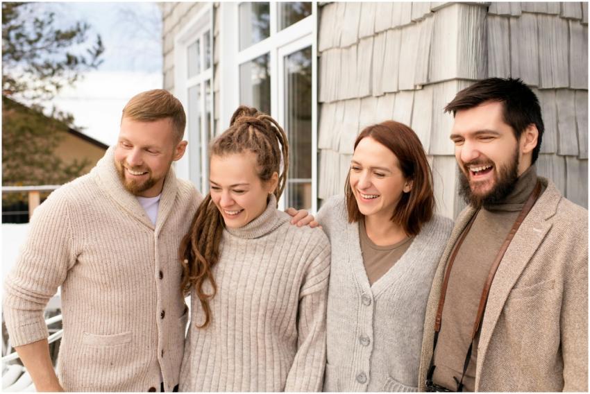 Four friends laughing and bonding outdoors in a co
