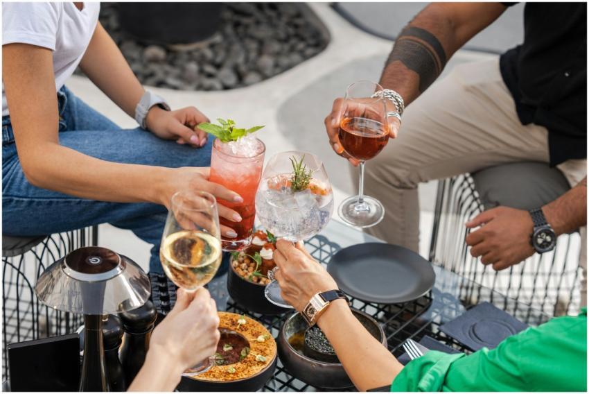 A group of friends toasting with cocktails and win