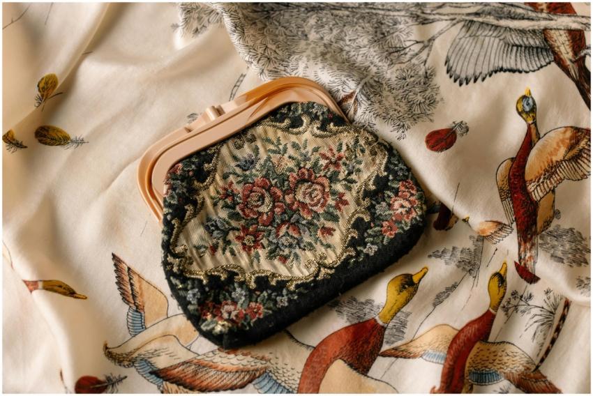 A vintage floral clutch bag resting on a patterned