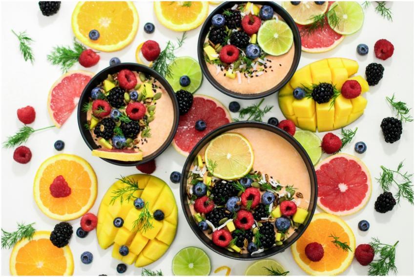 A colorful assortment of fresh fruit bowls featuri