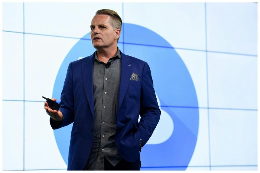 Confident businessman presenting with a microphone