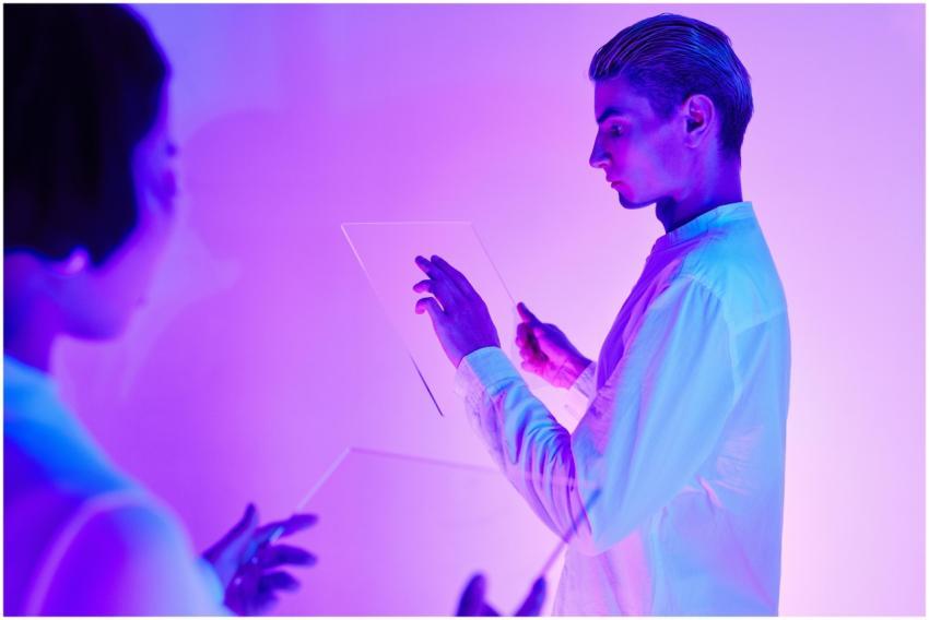 Two individuals engaging with futuristic transpare