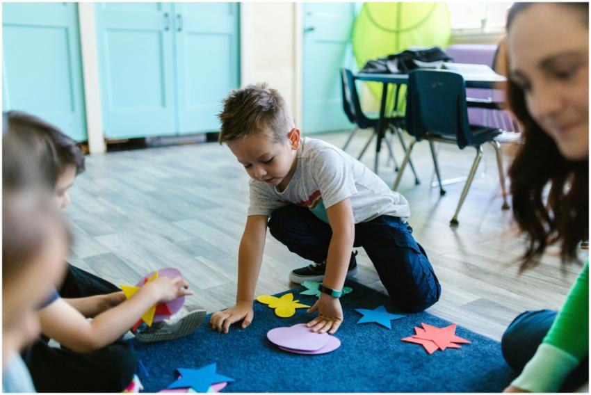 Children playing with colorful shapes in a classro