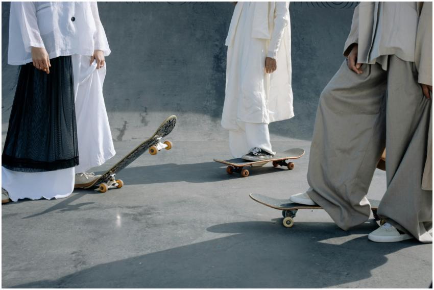 People in loose-fitting attire stand with skateboa
