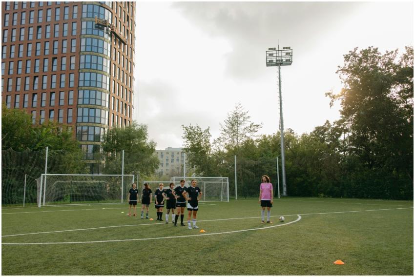 Female athletes training on a soccer field with fo