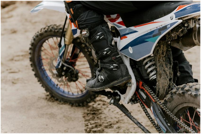 Close-up of a rider performing motocross on a dirt