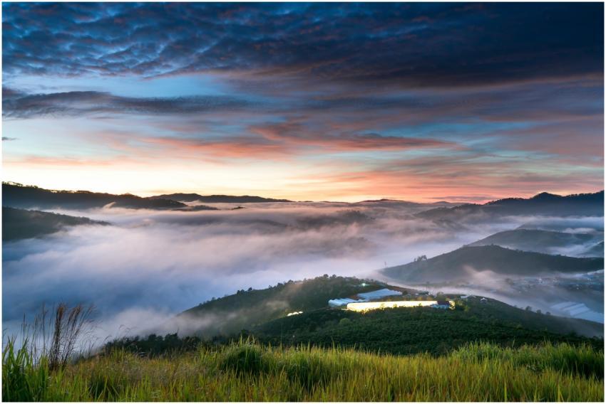 Stunning sunrise over foggy valley with vibrant sk