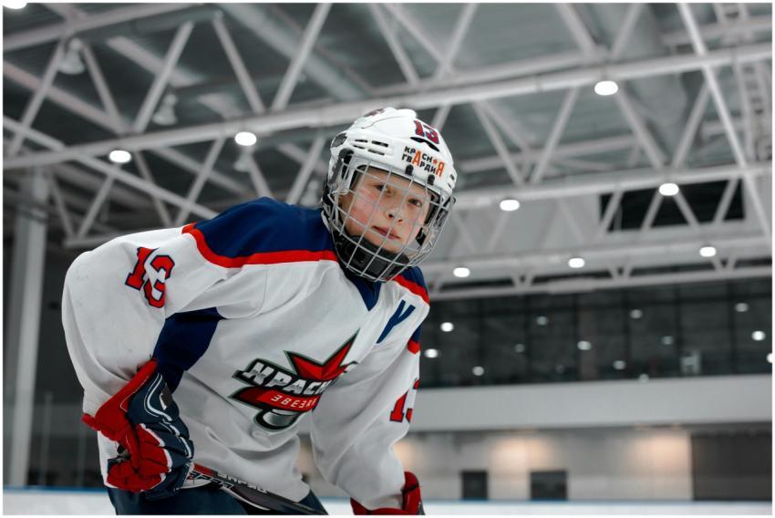 Dynamic shot of a young ice hockey player in full