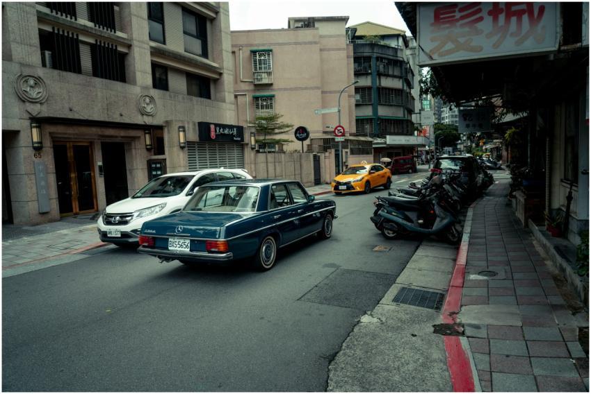 Vintage Mercedes Benz in bustling Taipei street sc