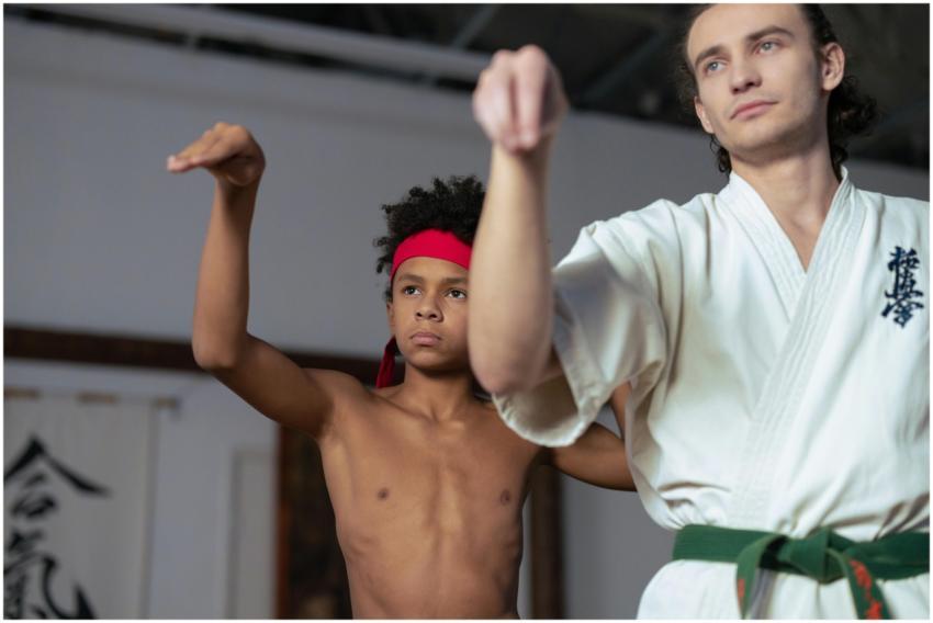 Young students practicing martial arts indoors wit