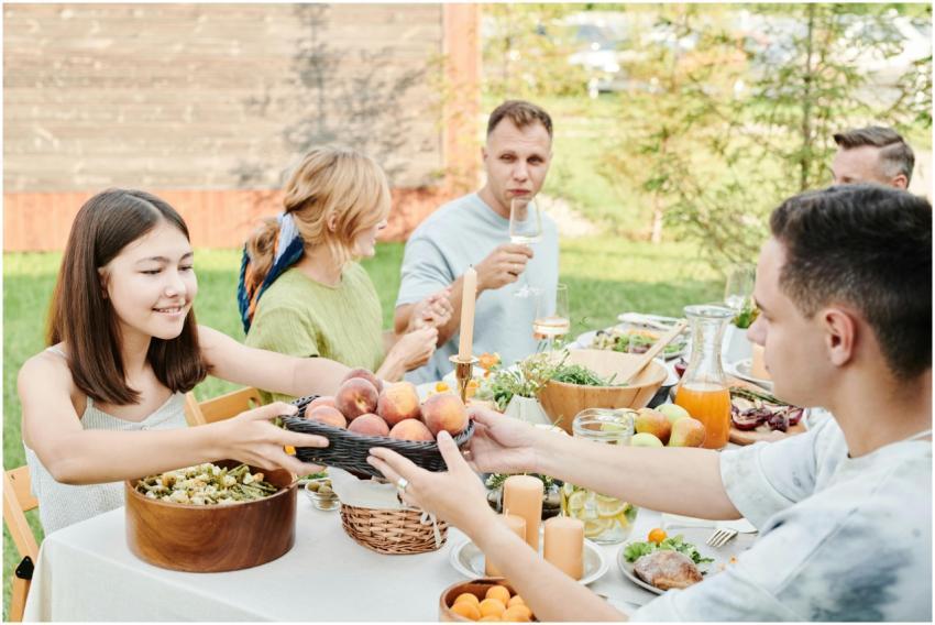 Family gathering for an outdoor lunch with fruits