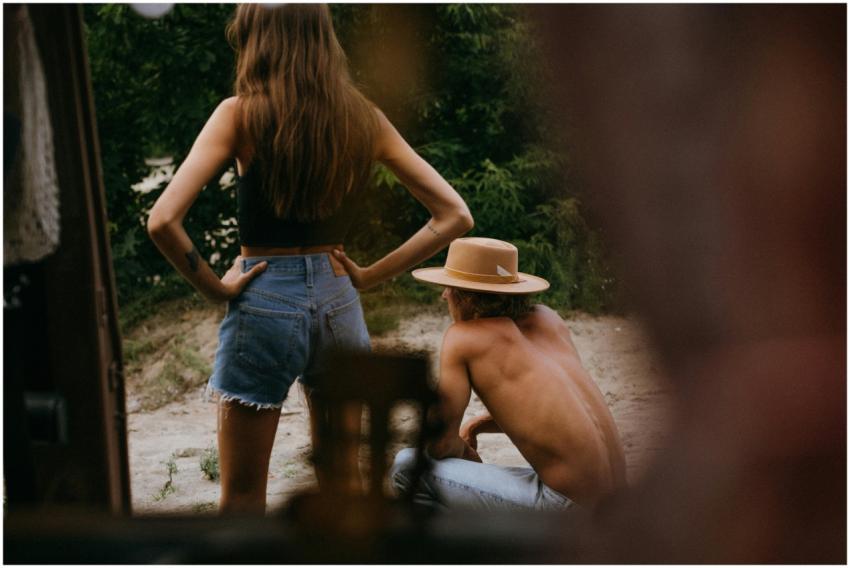 Two people enjoy a relaxing summer day outdoors, c