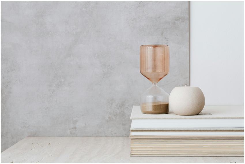 A serene minimalist setup featuring an hourglass a